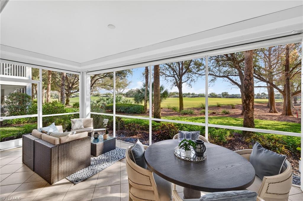 9201 Palmetto Ridge Drive, Unit 101 Estero, FL 34135 - Photo 20 of 29 Sunroom / solarium with outdoor lounge area and view of golf course