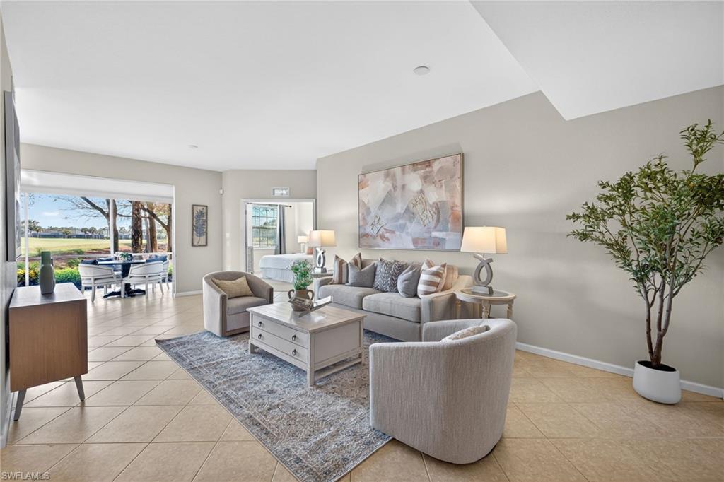 9201 Palmetto Ridge Drive, Unit 101 Estero, FL 34135 - Photo 2 of 29 Living area featuring light tile patterned floors and baseboards