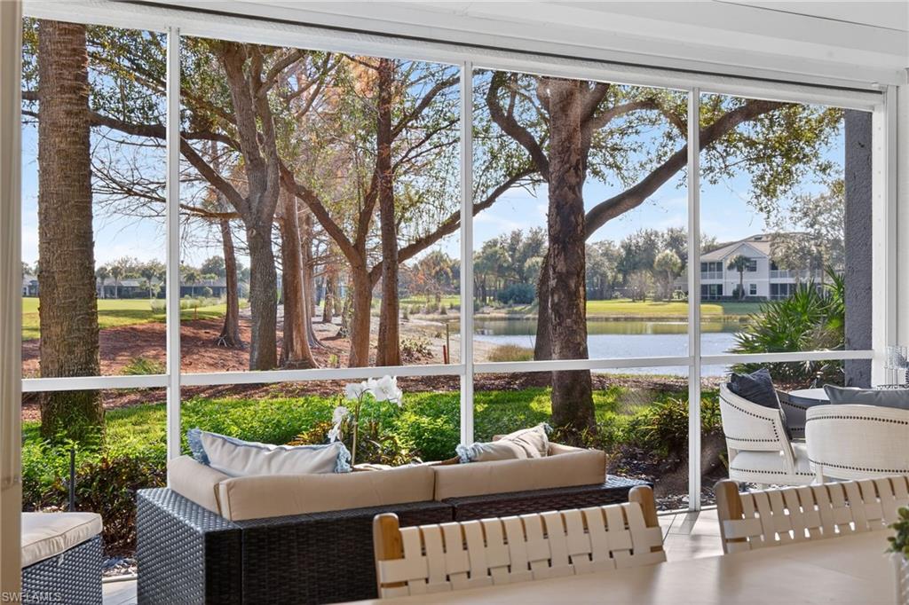 9201 Palmetto Ridge Drive, Unit 101 Estero, FL 34135 - Photo 22 of 29 Sunroom / solarium with outdoor seating and a water view