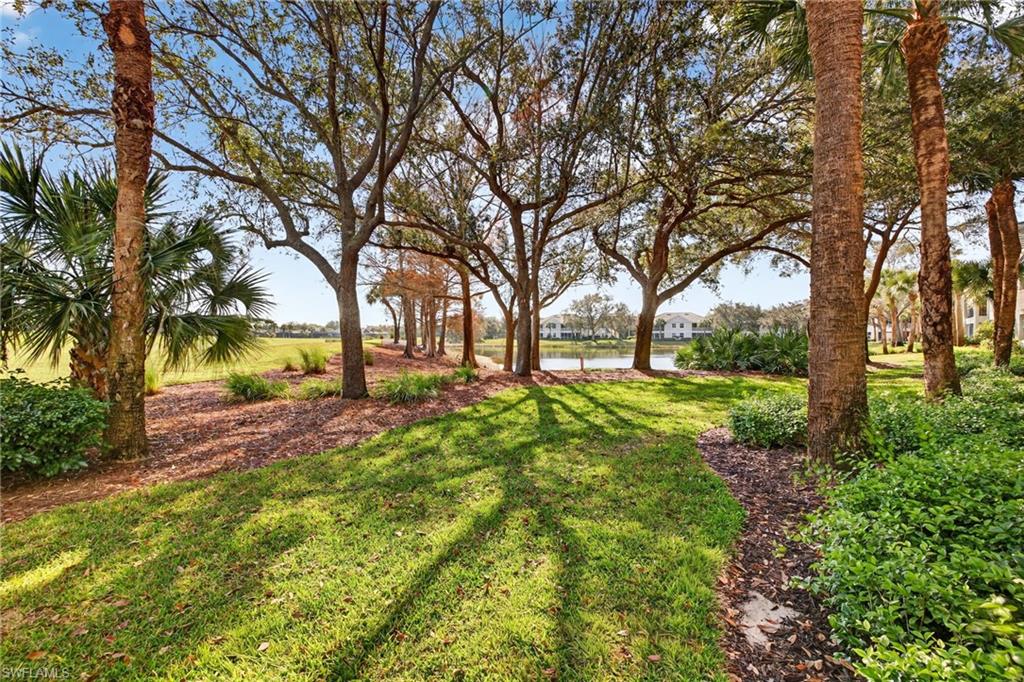 9201 Palmetto Ridge Drive, Unit 101 Estero, FL 34135 - Photo 24 of 29 View of grassy yard featuring a water view