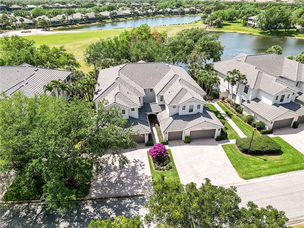 9201 Palmetto Ridge Drive, Unit 101 Estero, FL 34135 - Photo 28 of 29 Aerial perspective of suburban area with a large body of water and a golf course
