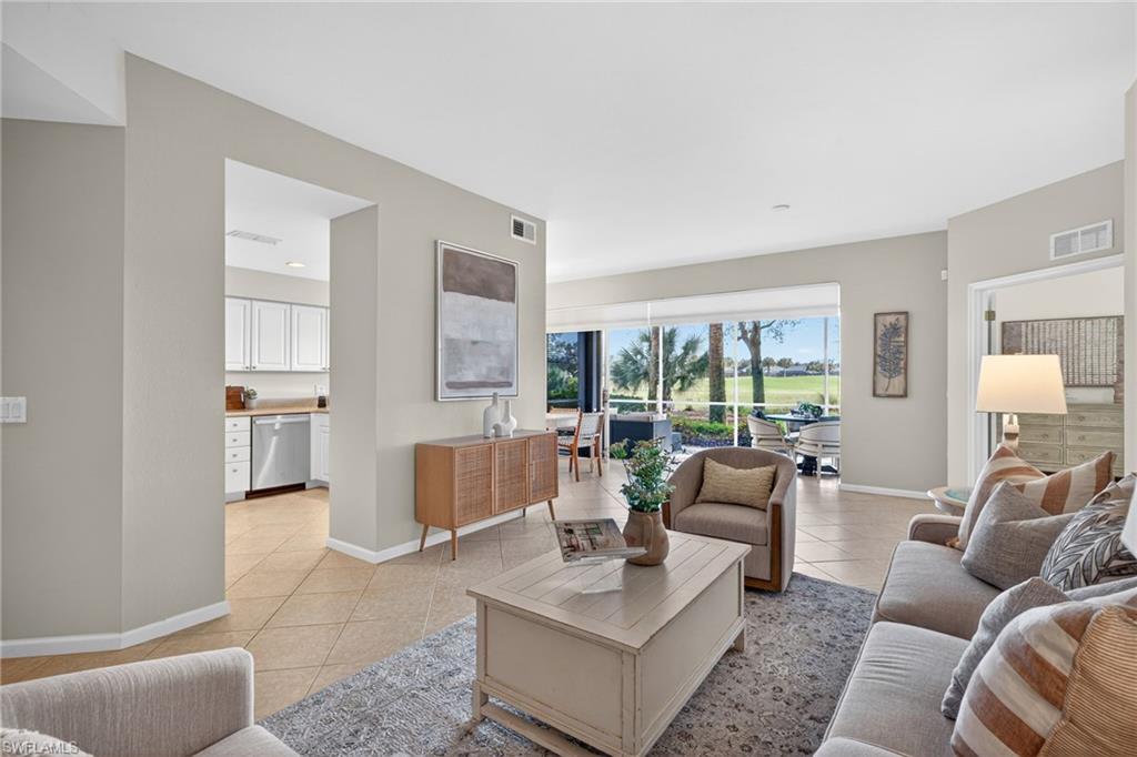 9201 Palmetto Ridge Drive, Unit 101 Estero, FL 34135 - Photo 3 of 29 Living room featuring baseboards and light tile patterned flooring