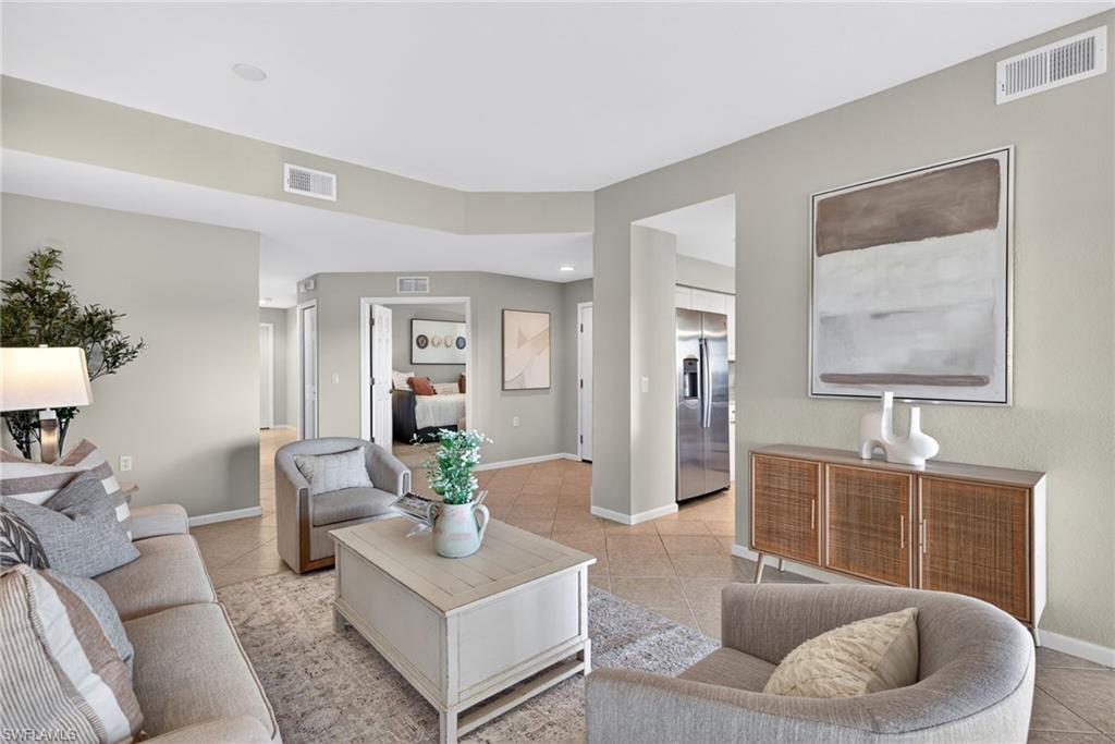 9201 Palmetto Ridge Drive, Unit 101 Estero, FL 34135 - Photo 4 of 29 Living room with baseboards