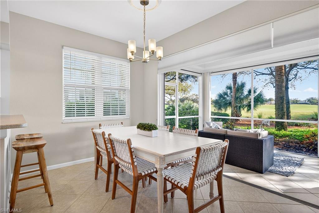 9201 Palmetto Ridge Drive, Unit 101 Estero, FL 34135 - Photo 6 of 29 Dining area with suspended lighting and light tile patterned floors