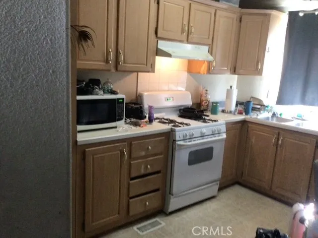 a kitchen with appliances cabinets and a sink