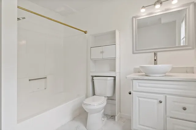 a bathroom with a toilet a sink and bathtub