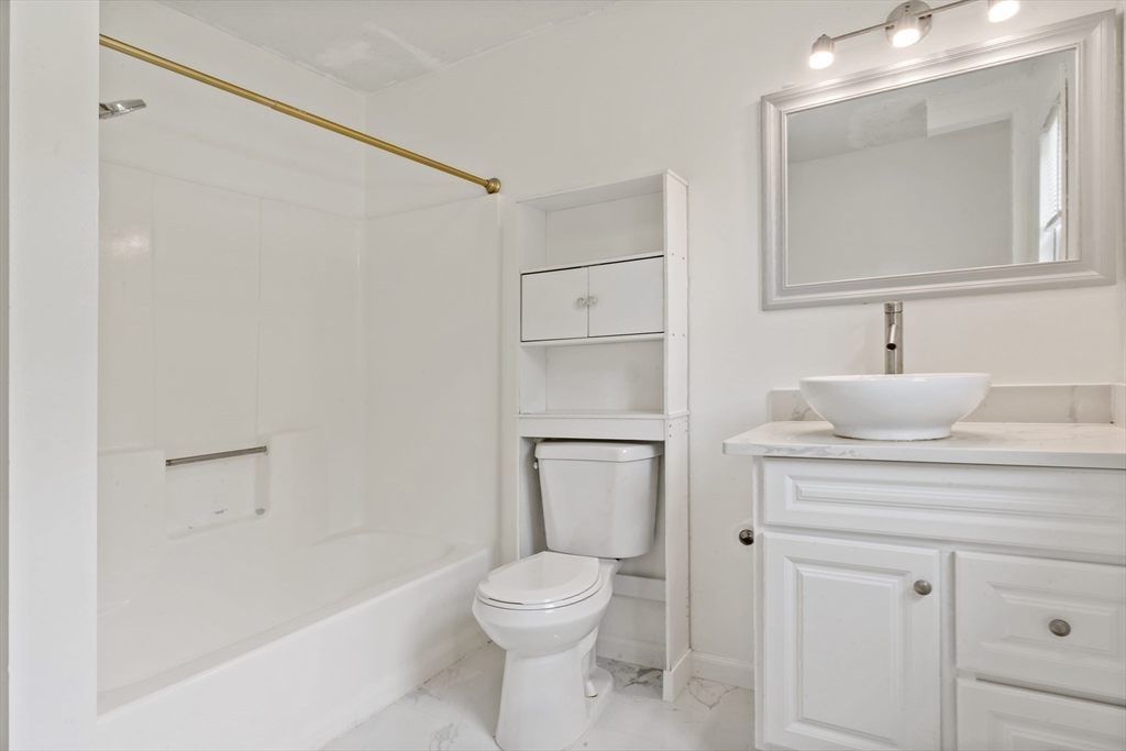 45 Fourth Street, Unit RIGHT Worcester, MA 01602 - Photo 13 of 21 a bathroom with a toilet a sink and bathtub