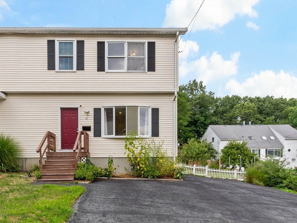 45 Fourth Street, Unit RIGHT Worcester, MA 01602 - Photo 20 of 21 a front view of a house with a yard