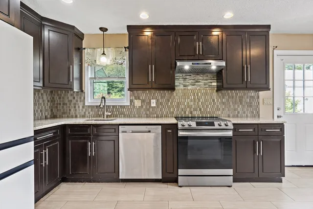 a kitchen with a sink stove and cabinets
