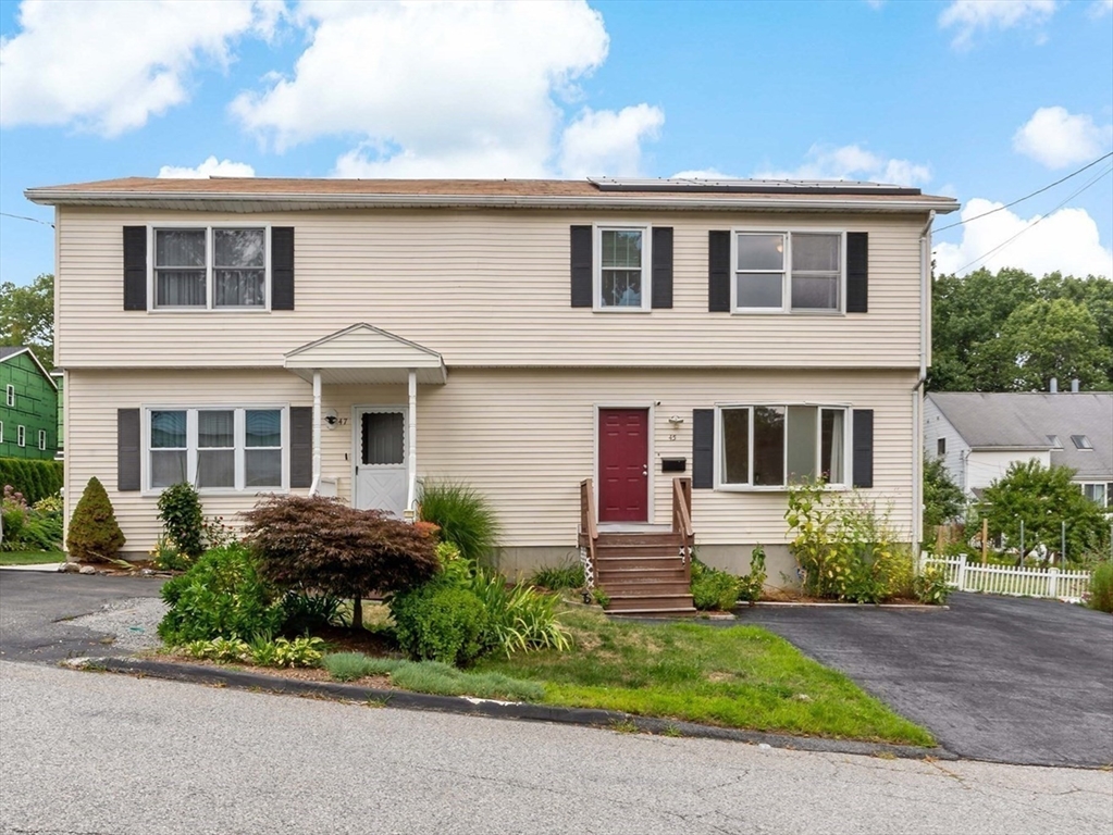 45 Fourth Street, Unit RIGHT Worcester, MA 01602 - Photo 21 of 21 a front view of a house with a yard and outdoor seating