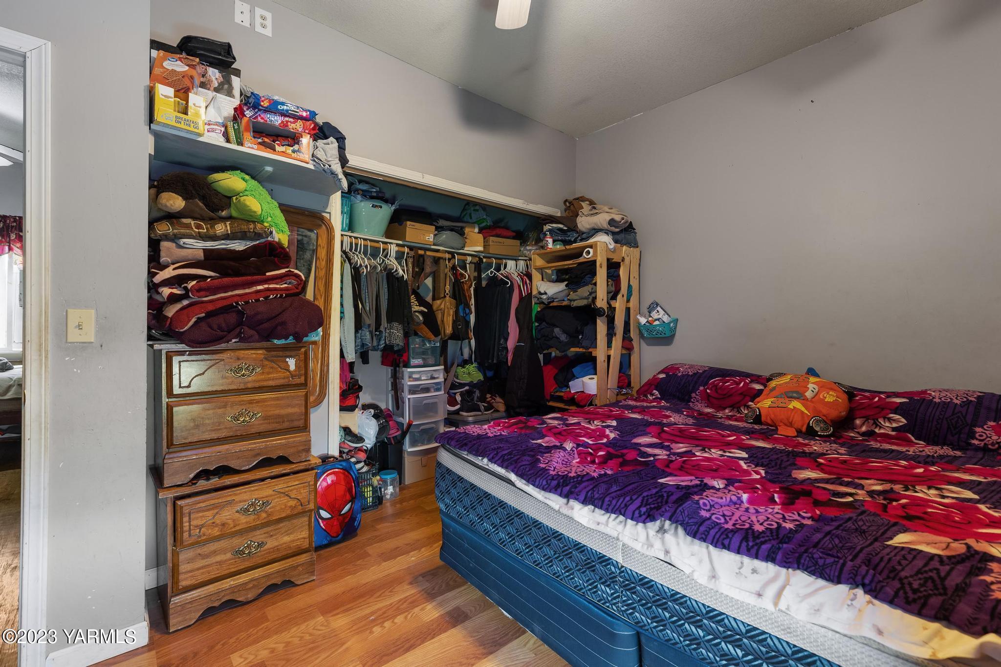 131 Ogle Road Grandview, WA 98930 - Photo 13 of 41 a room with lots of different colored cloths