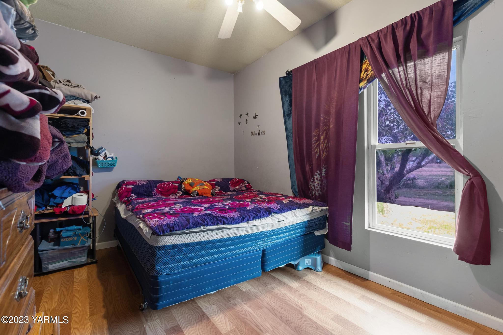 131 Ogle Road Grandview, WA 98930 - Photo 14 of 41 a bedroom with a bed and a window