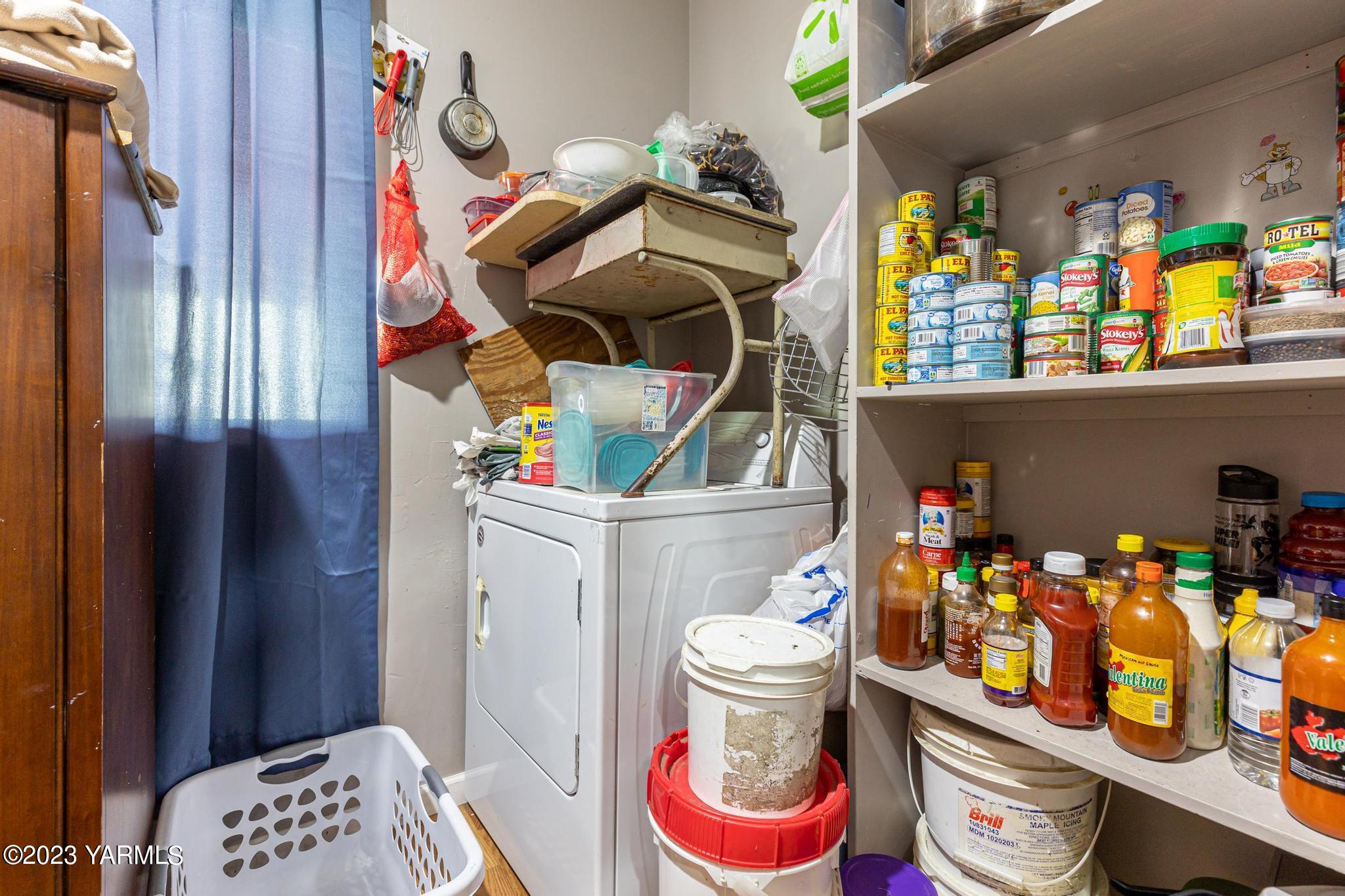 131 Ogle Road Grandview, WA 98930 - Photo 20 of 41 a room with lots of clutter and cabinets