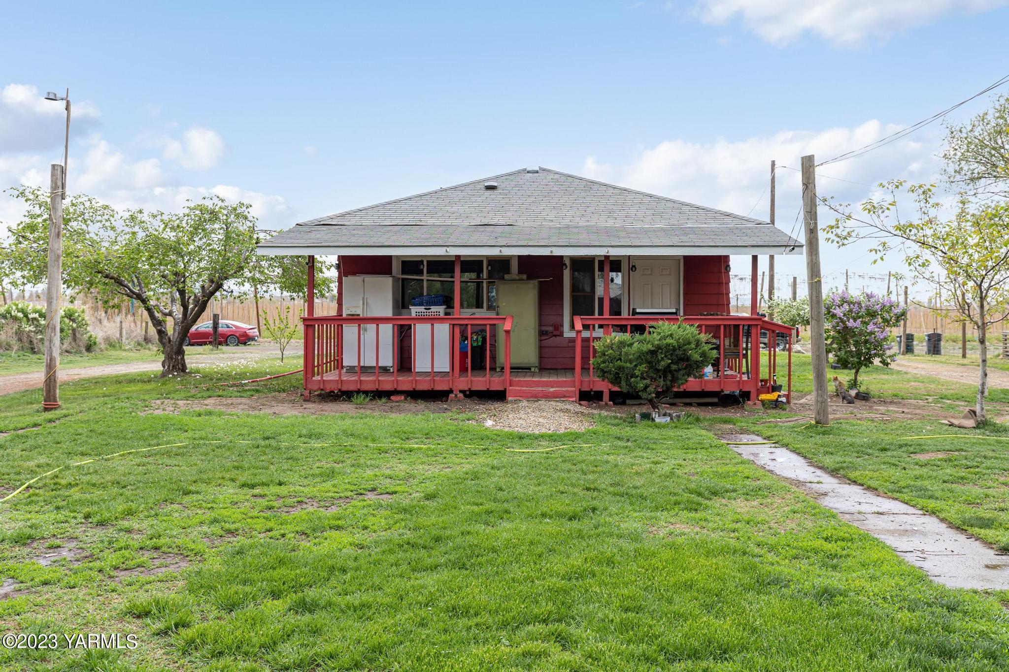 131 Ogle Road Grandview, WA 98930 - Photo 25 of 41 a view of an house with backyard space and garden