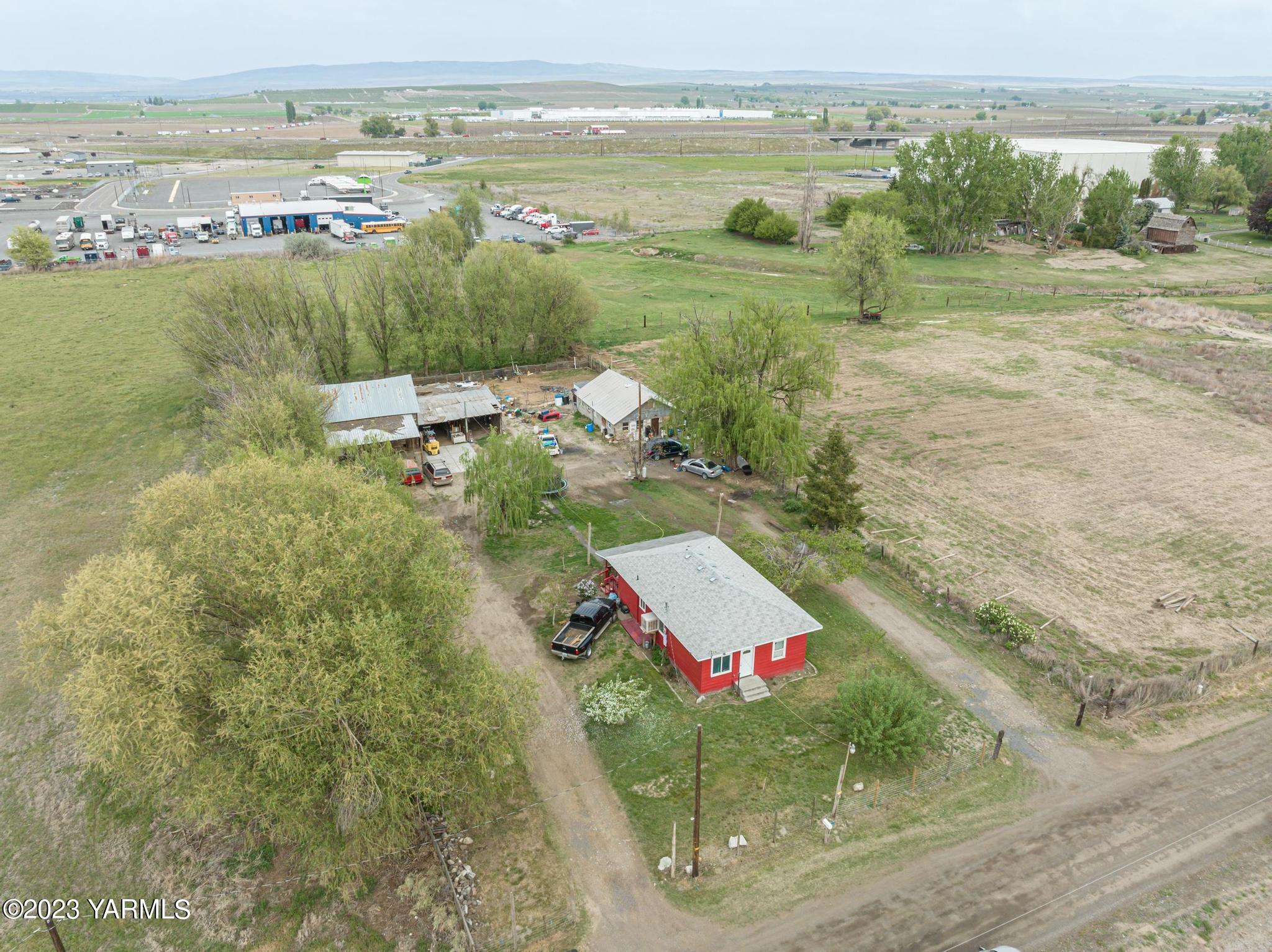 131 Ogle Road Grandview, WA 98930 - Photo 6 of 41 an aerial view of residential houses with outdoor space and river