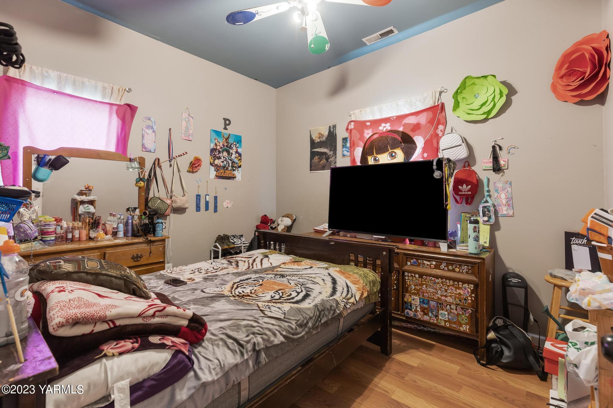 131 Ogle Road Grandview, WA 98930 - Photo 9 of 41 a bedroom with a bed and a flat screen tv
