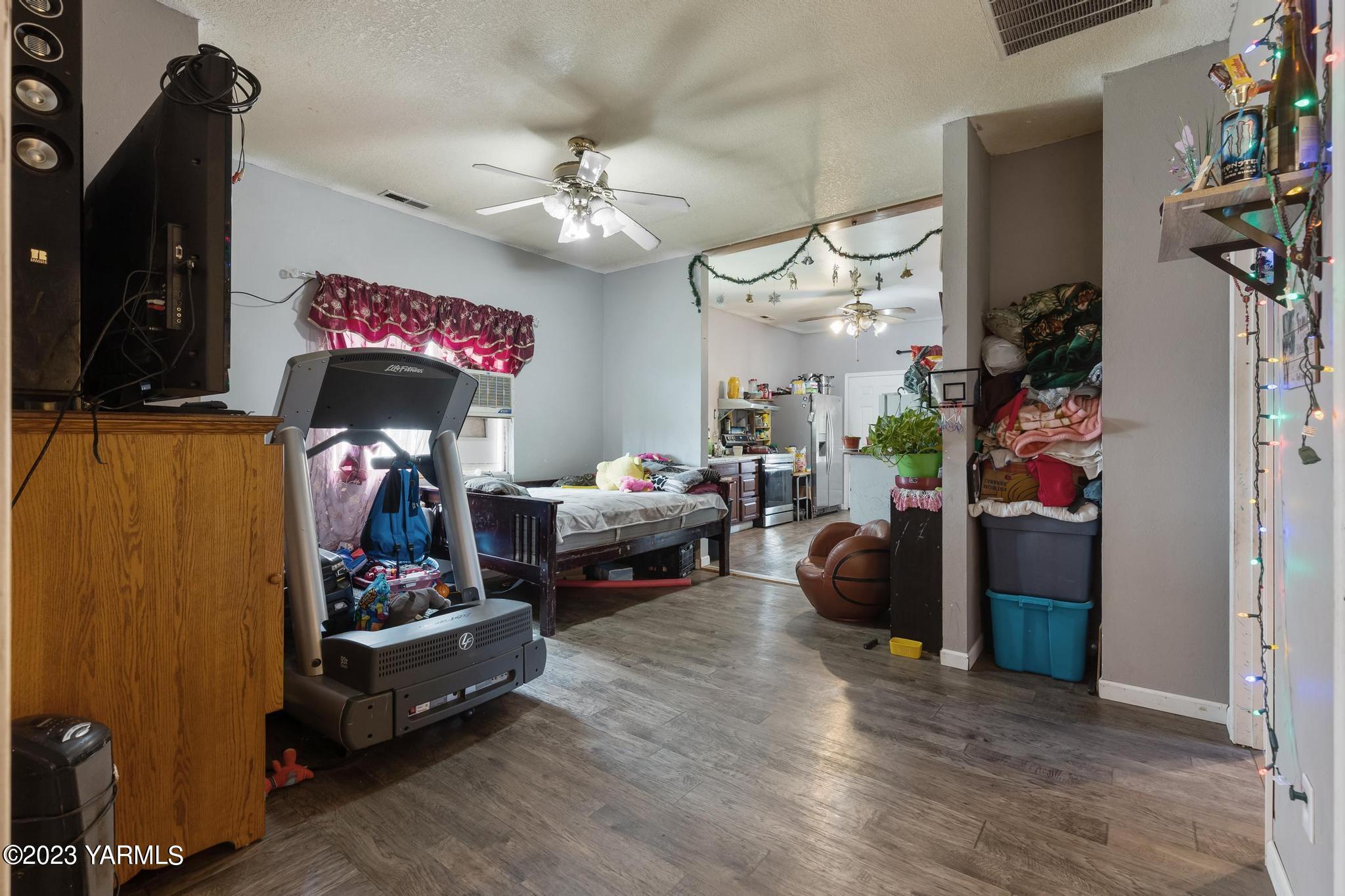 131 Ogle Road Grandview, WA 98930 - Photo 10 of 41 a bedroom with furniture and a flat screen tv