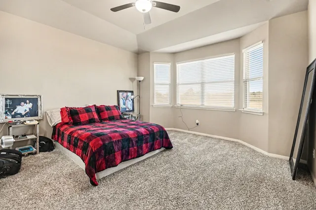 a spacious bedroom with a bed and a window