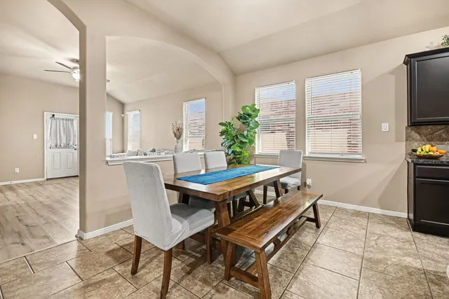 a dining room with furniture and window