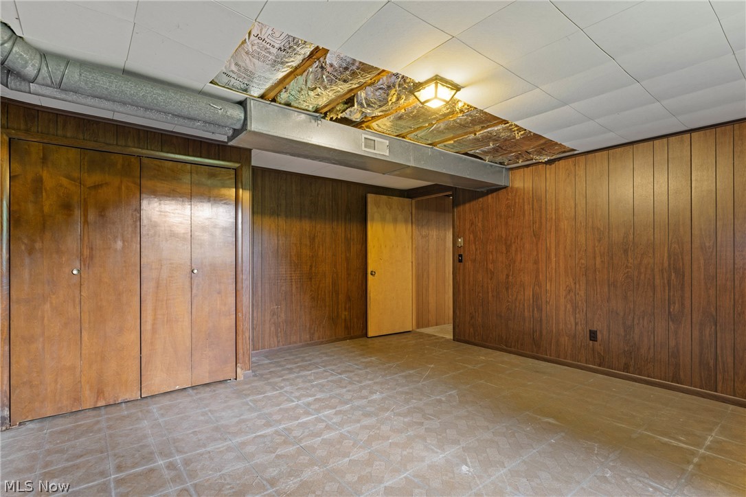 16295 Sperry Road Vermilion, OH 44089 - Photo 38 of 48 Basement featuring tile flooring and wood walls