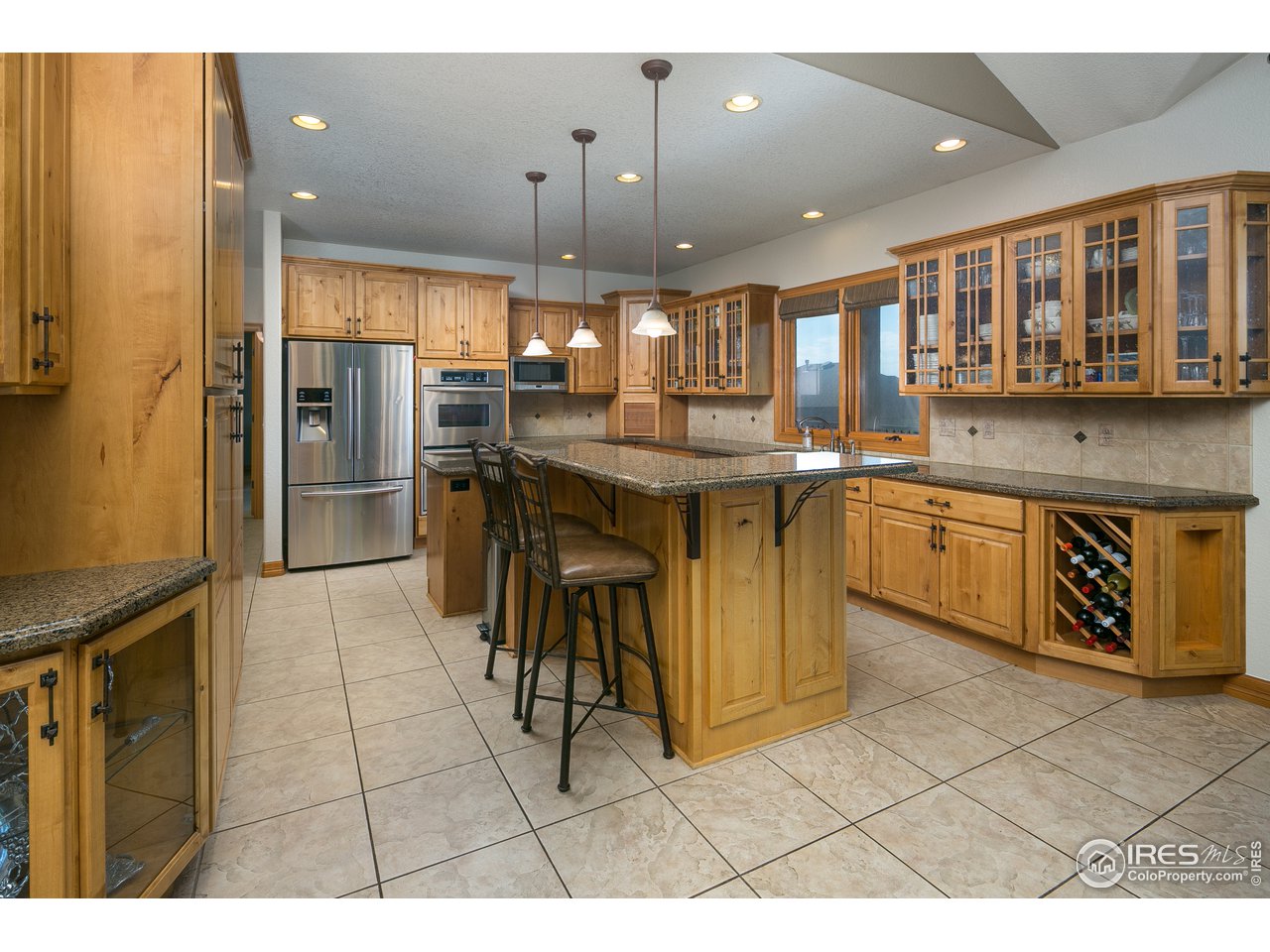 7507 Plateau Road Greeley, CO 80634 - Photo 2 of 35 Stunning Kitchen w/ 42" Cabs, crown molding, granite tops & SS Appliances