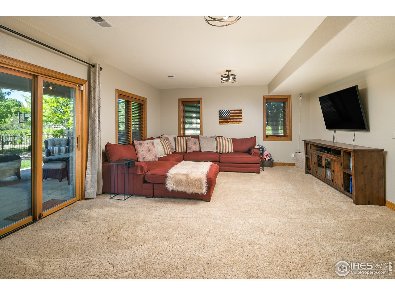 7507 Plateau Road Greeley, CO 80634 - Photo 24 of 35 Lower Level Living Room w/ Patio Access