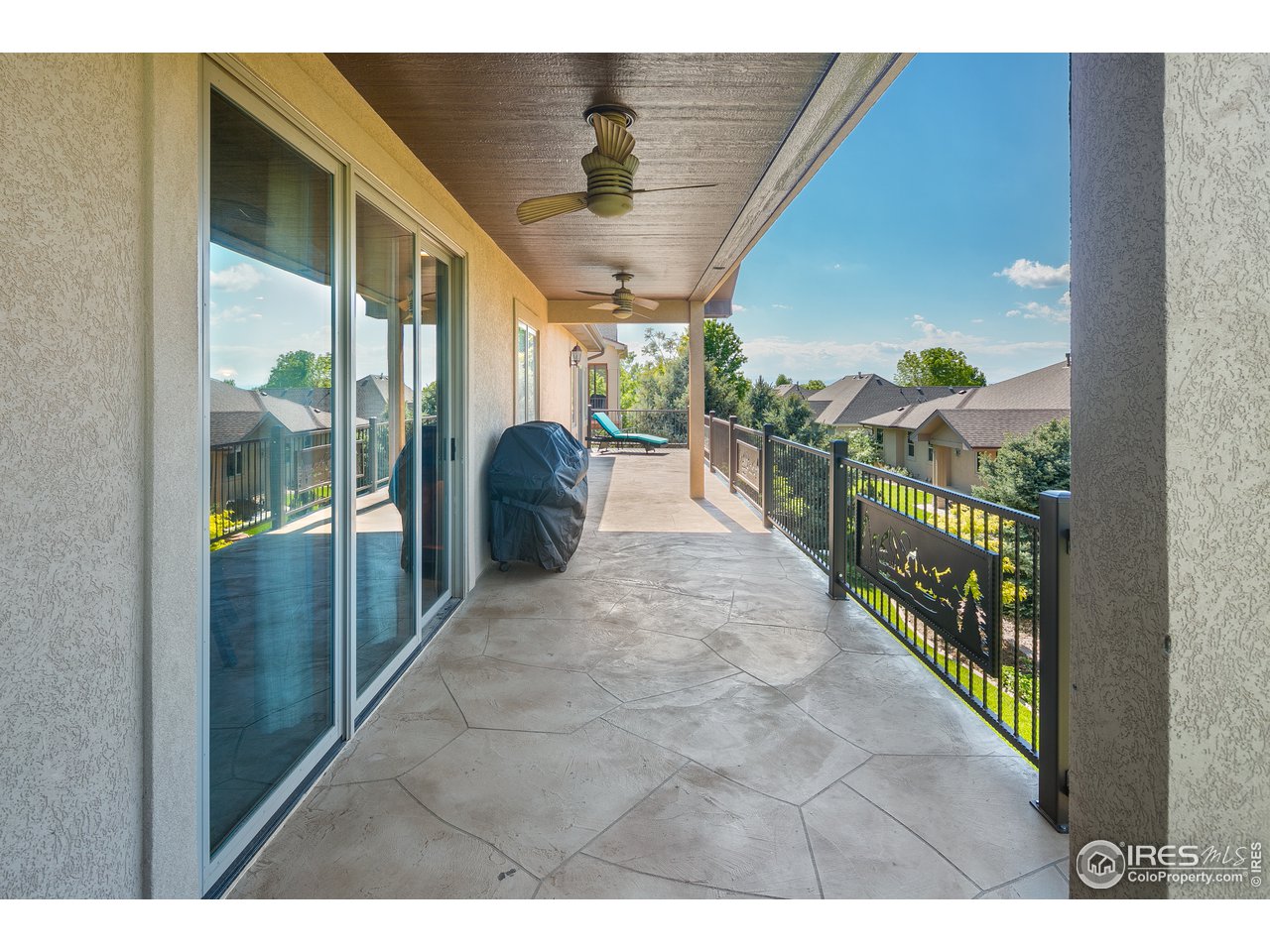 7507 Plateau Road Greeley, CO 80634 - Photo 33 of 35 Custom concrete patio, partially covered w/ custom iron railing