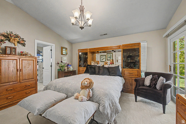 3034 Swiss Drive Santa Clara, UT 84765 - Photo 41 of 59 Spacious room featuring vaulted ceilings, a multi-light chandelier, a built-in wall unit with mirrored backing and display cabinetry, and double French doors with interior blinds