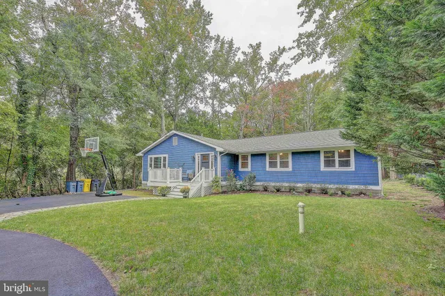 a brick house with trees in front of it