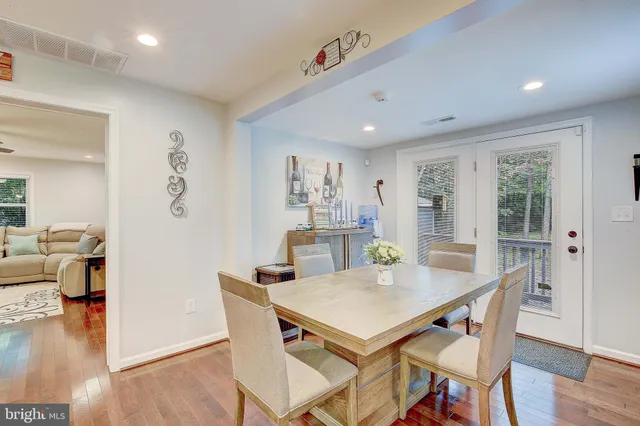 a view of a dining room with furniture wooden floor and a chandelier