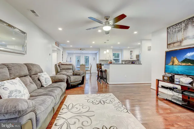 a living room with furniture and kitchen view