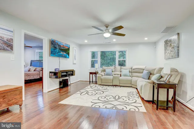 a living room with furniture and a wooden floor
