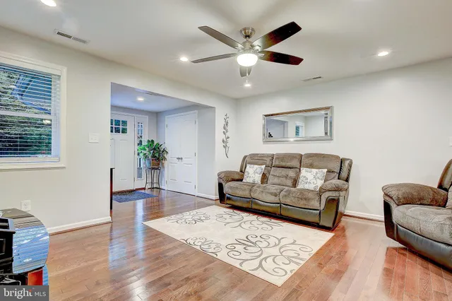 a living room with furniture and a wooden floor