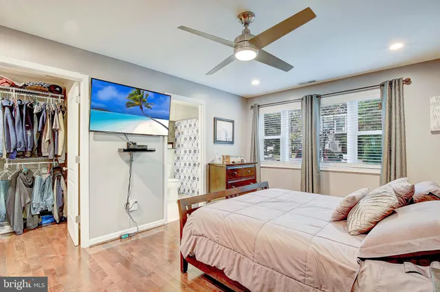 a bedroom with a large bed and a large window