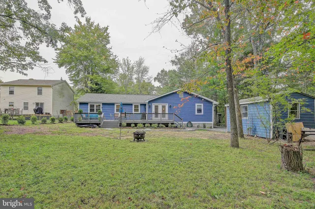a house view with a sitting space and garden