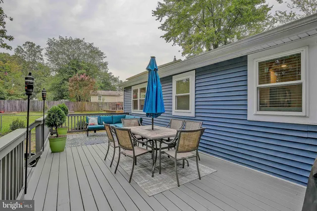a view of a house with patio and wooden floor