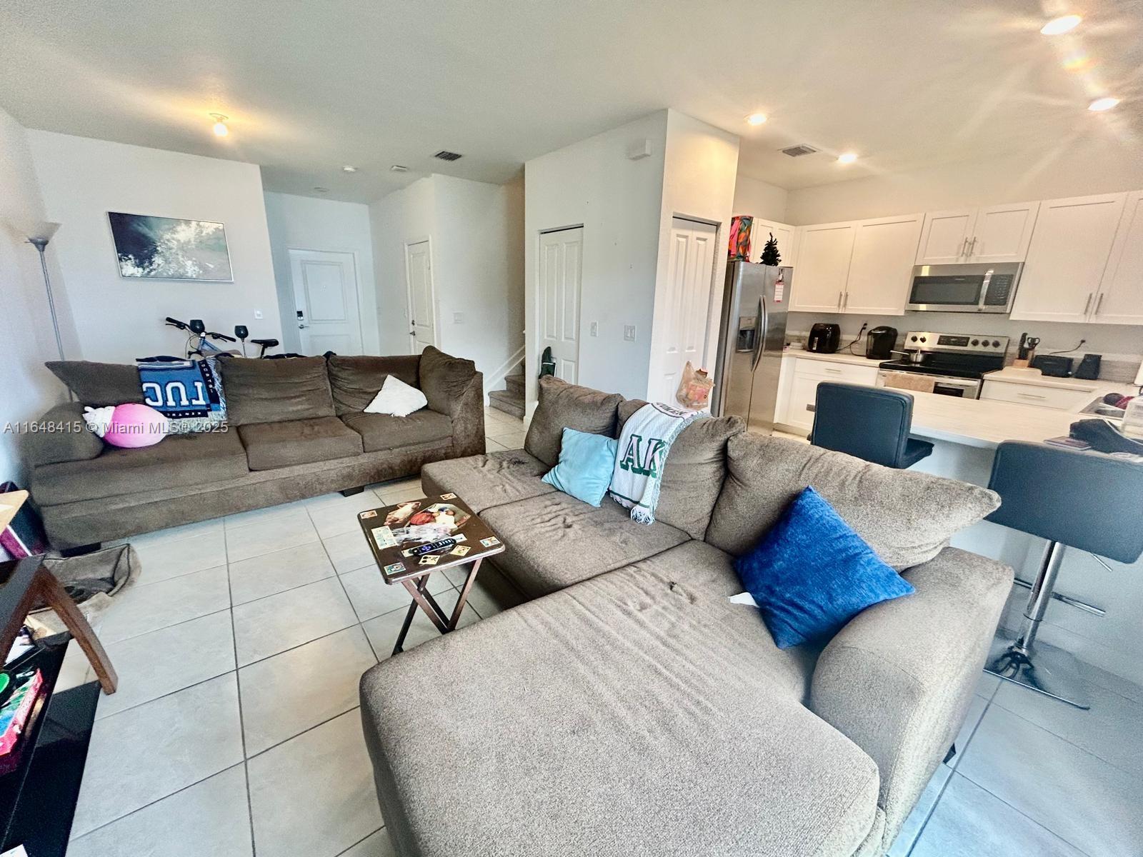 20626 Northeast 5th Place, Unit 20626 Miami, FL 33179 - Photo 11 of 34 a living room with furniture and kitchen view