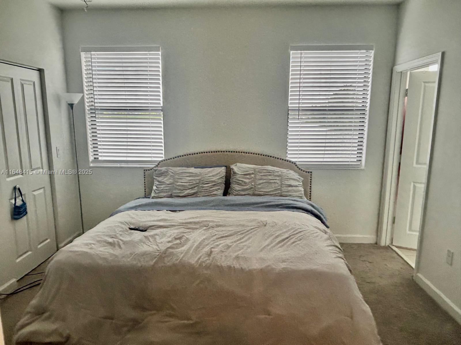 20626 Northeast 5th Place, Unit 20626 Miami, FL 33179 - Photo 14 of 34 a bedroom with a bed and a window