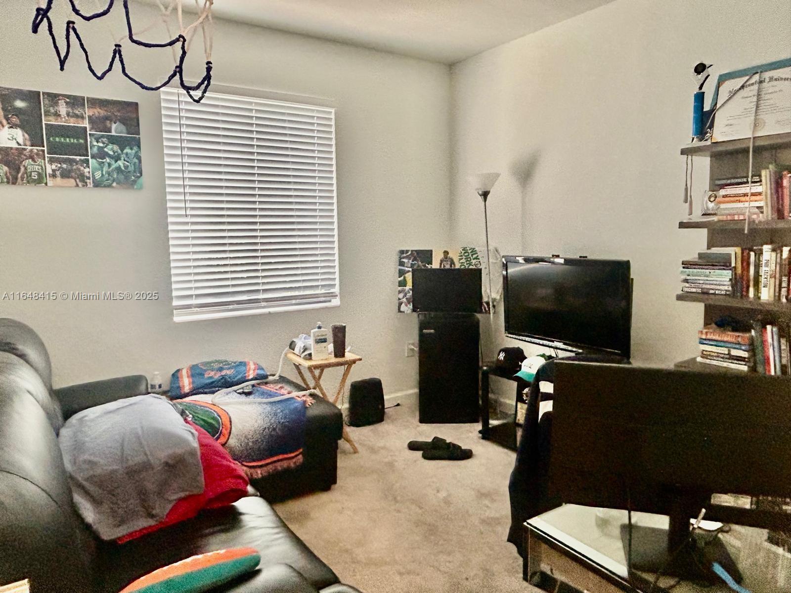 20626 Northeast 5th Place, Unit 20626 Miami, FL 33179 - Photo 20 of 34 a bedroom with furniture and a flat screen tv