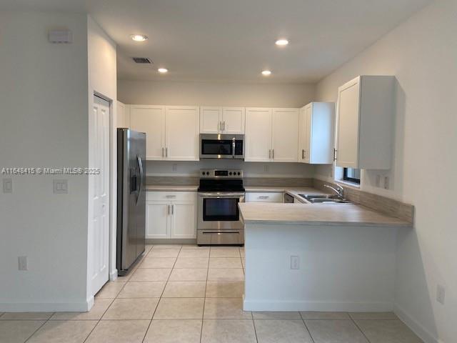 20626 Northeast 5th Place, Unit 20626 Miami, FL 33179 - Photo 2 of 34 a kitchen with kitchen island stainless steel appliances a stove refrigerator sink and cabinets