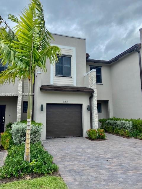 20626 Northeast 5th Place, Unit 20626 Miami, FL 33179 - Photo 24 of 34 a front view of a house with a yard and garage