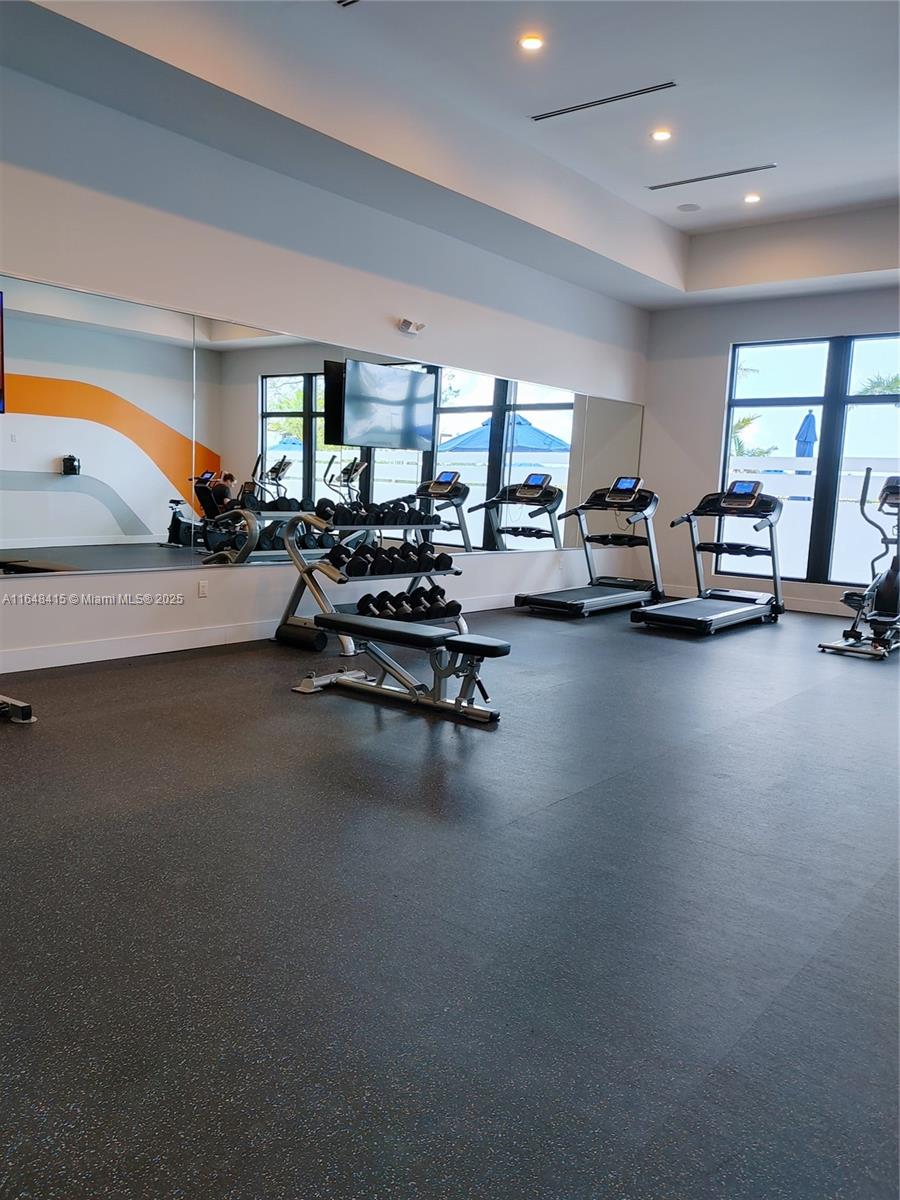 20626 Northeast 5th Place, Unit 20626 Miami, FL 33179 - Photo 28 of 34 a living room with furniture gym and a large window