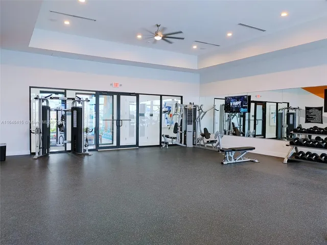 a living room filled with furniture and a dining table