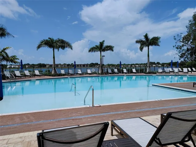 a view of a patio with swimming pool table and chairs