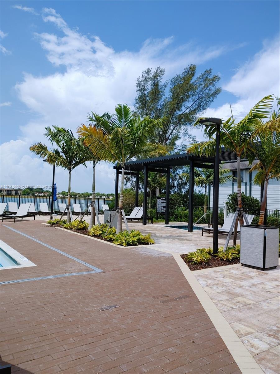 20626 Northeast 5th Place, Unit 20626 Miami, FL 33179 - Photo 33 of 34 a view of a swimming pool with a patio