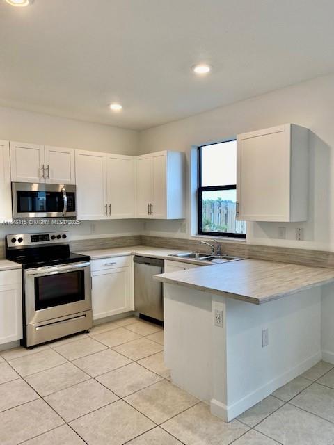 20626 Northeast 5th Place, Unit 20626 Miami, FL 33179 - Photo 7 of 34 a kitchen with stainless steel appliances granite countertop a stove a sink and a microwave