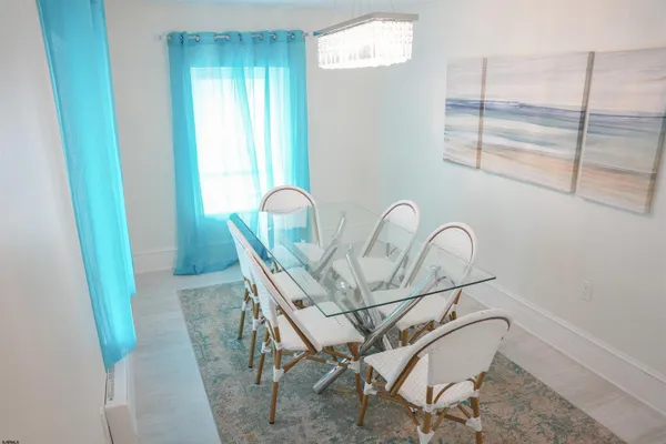 a view of a dining room with furniture and window