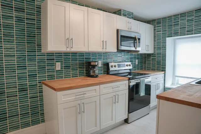 a kitchen with a sink stove and cabinets