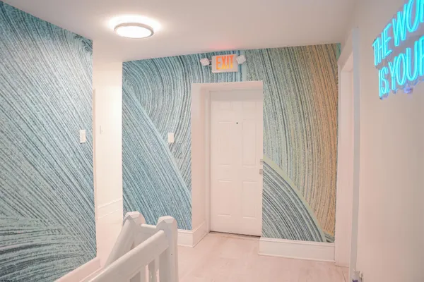 a view of a hallway to a house and stairs