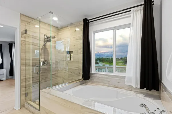 a bathroom with a bathtub and a shower